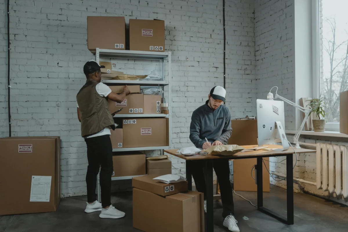Two men shipping packages.
