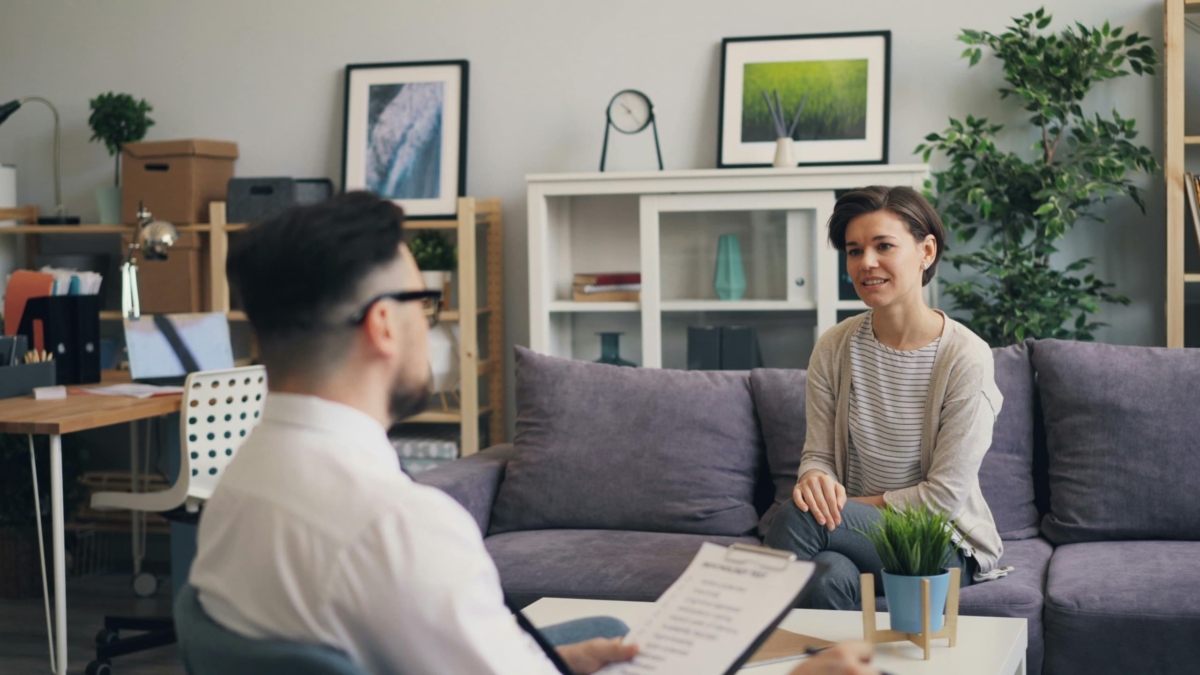 Woman having a therapy session with her male counsellor.