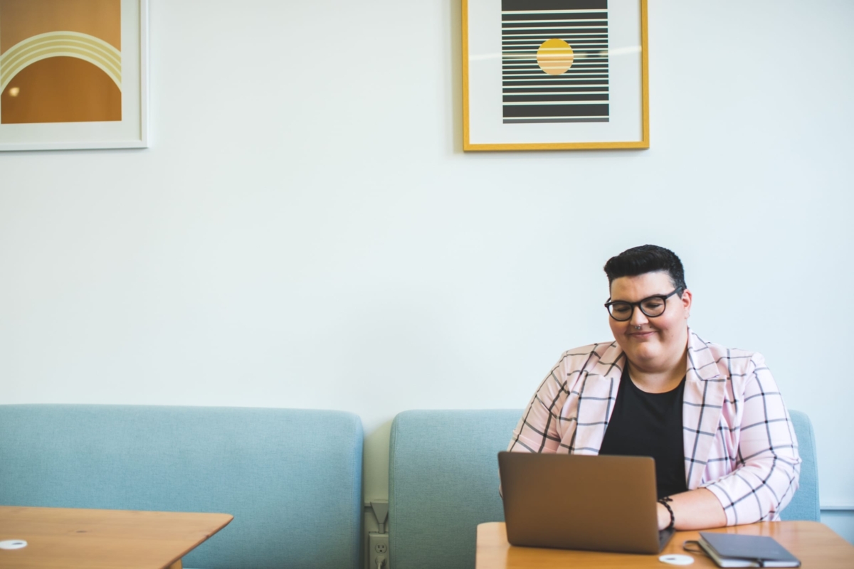 Man working on his laptop in an open concept office.